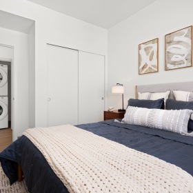 a bedroom with a bed and a lamp