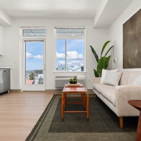 a studio with a couch and a kitchen