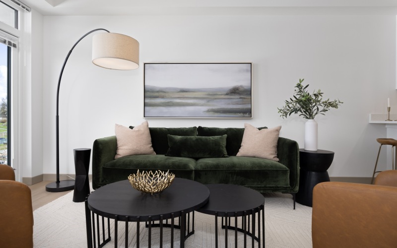 a living room with a couch, coffee table and chairs