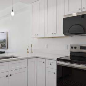 a kitchen with white cabinets