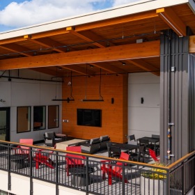 rooftop lounge with table chairs and wall mounted tv